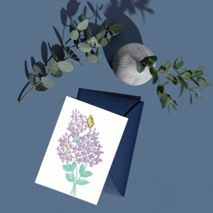 Nature Collection watercolor lilac greeting card, fully visible with a navy envelope and leafy stems on a blue surface.
